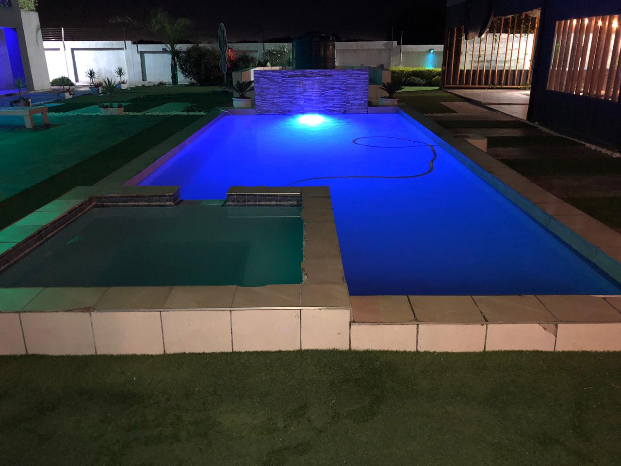 Prestige Pool Care illuminated pool at night